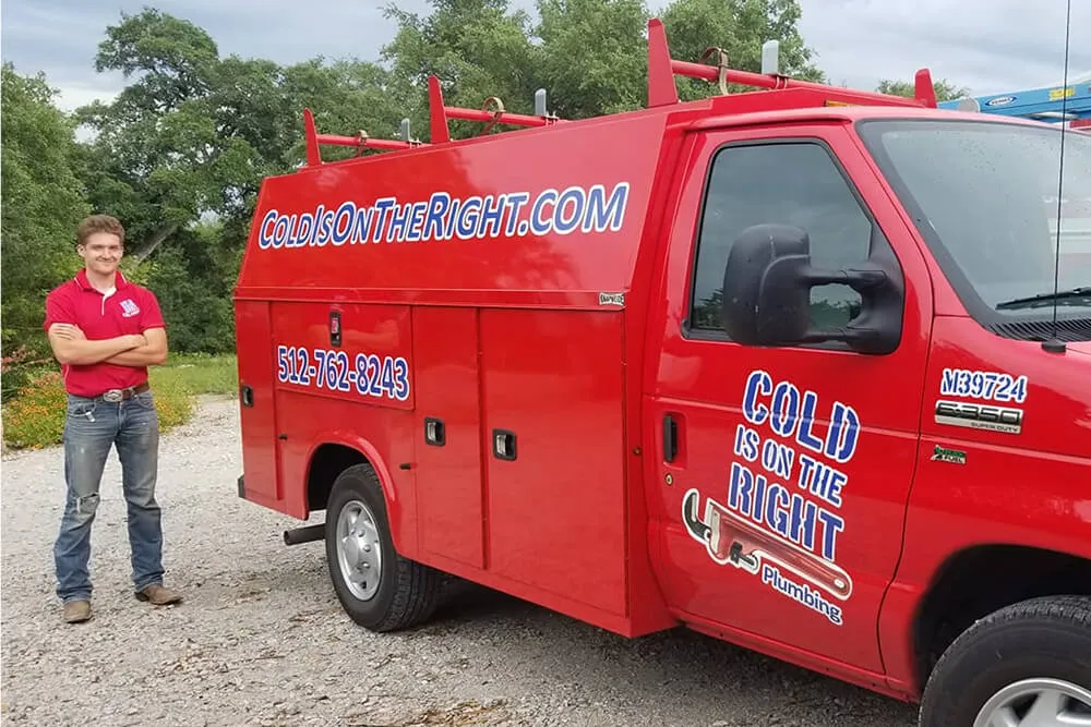 Man standing with red Cold Is On The Right Plumbing van.