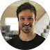 Smiling man in black shirt.