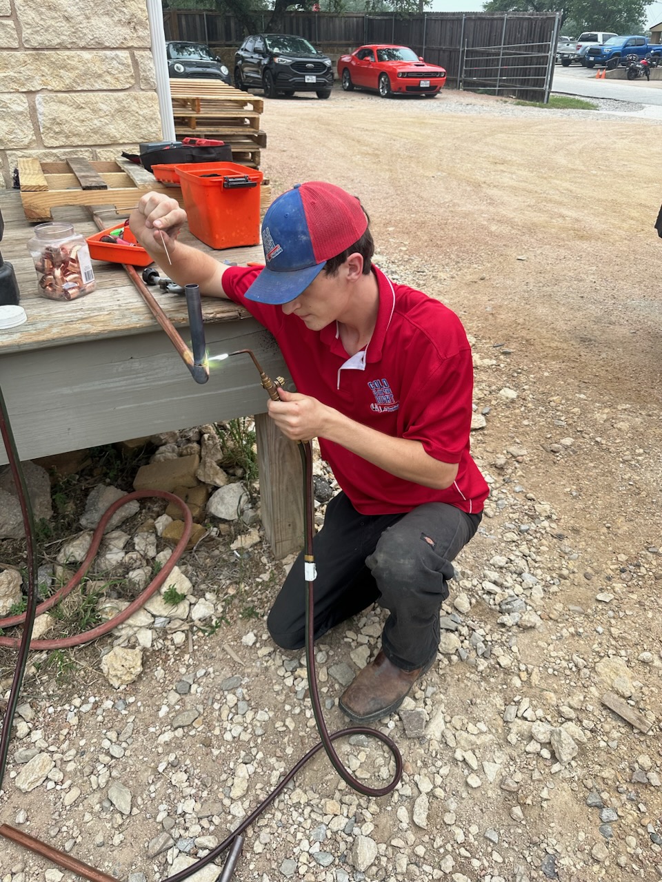 Apprentice technician being trained on brazing techniques at Cold Is On The Right Plumbing & Air