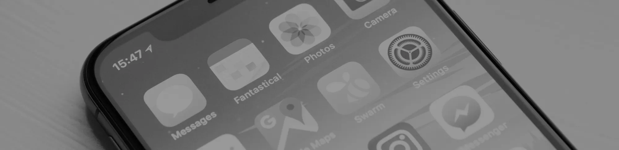 iOS開発を表現するアプリのアイコンが表示されたiPhone画面のクローズアップ。