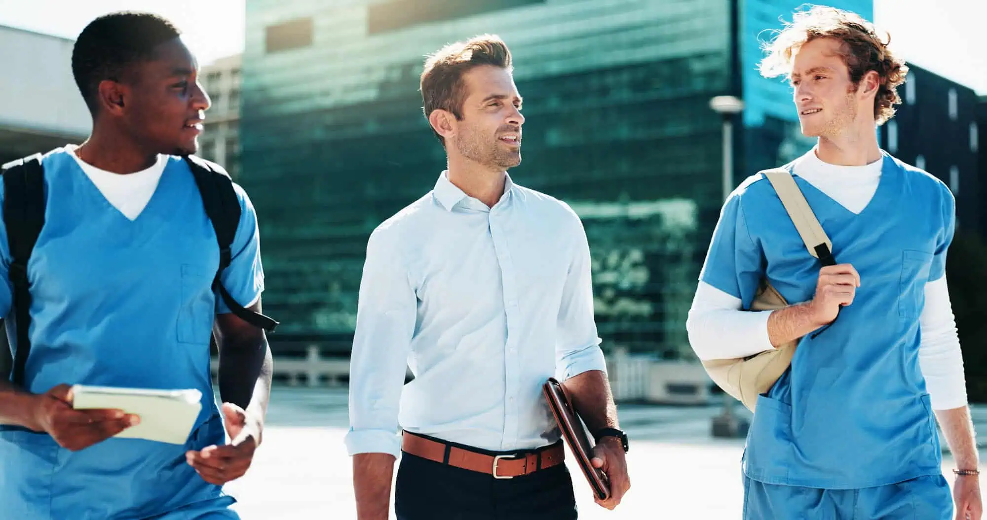 professional men and male nurses walking and talking together