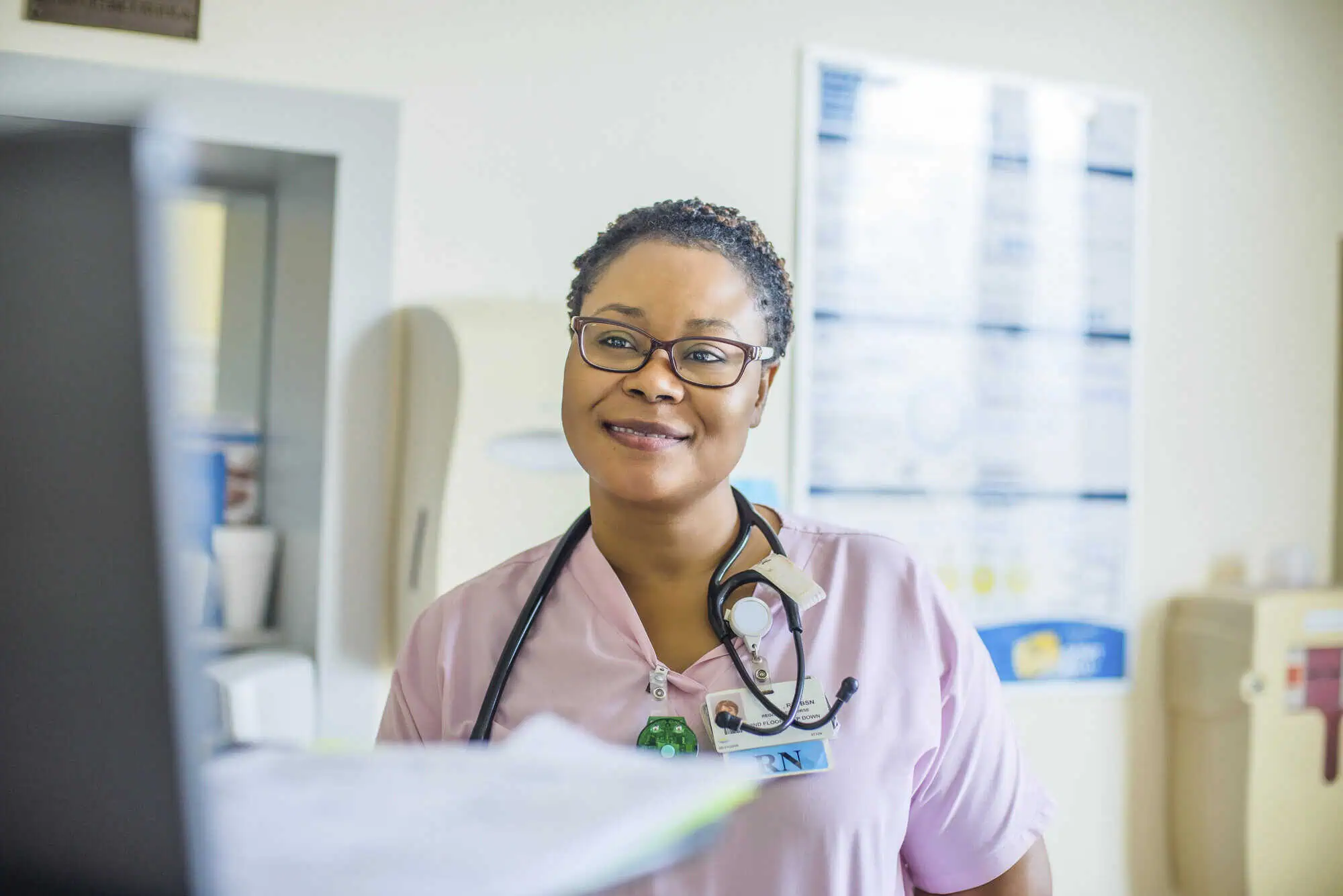 Registered nurse at her nurse computer station