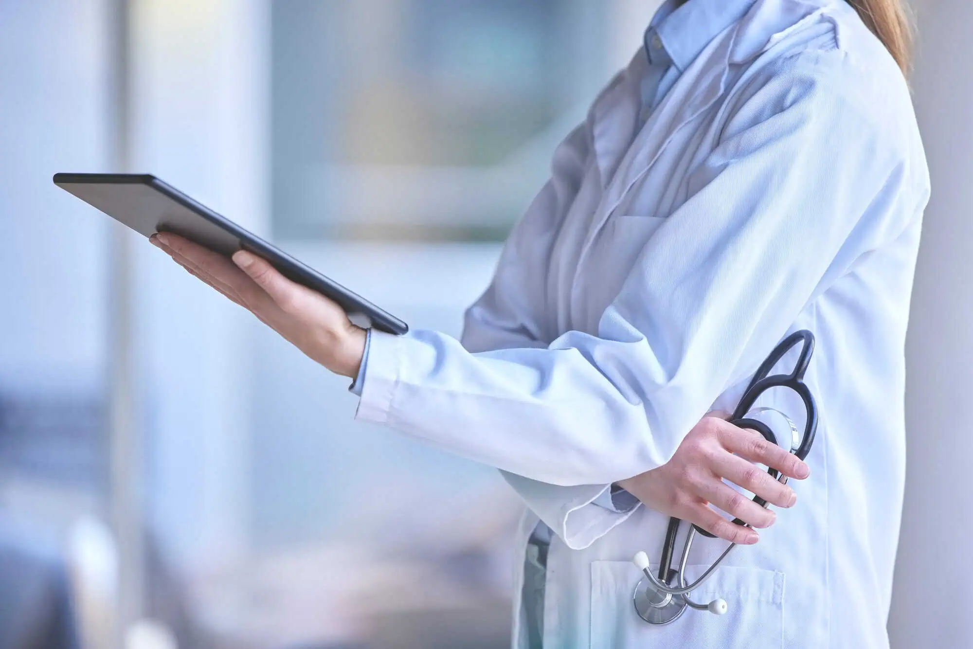 doctor looking at tablet in hospital