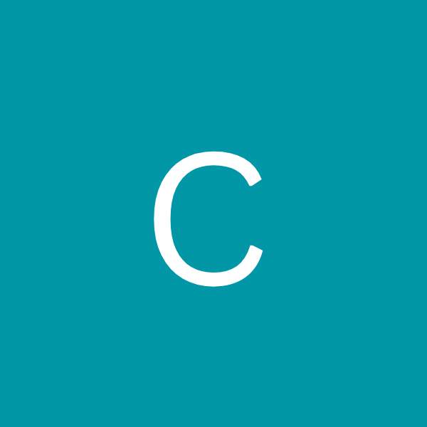 Close-up of a smiling young couple touching foreheads with eyes closed, showing affection.