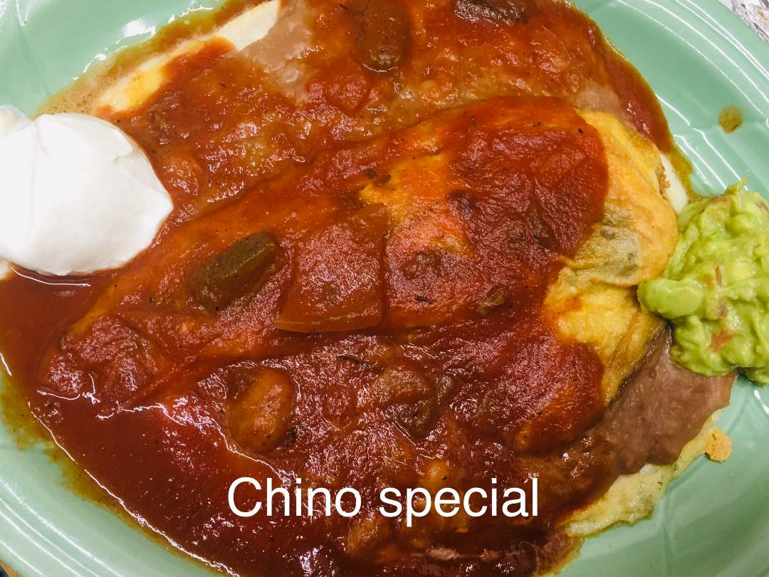 Chino special dish presented on a plate, featuring a Chile Relleno topped with red sauce.
