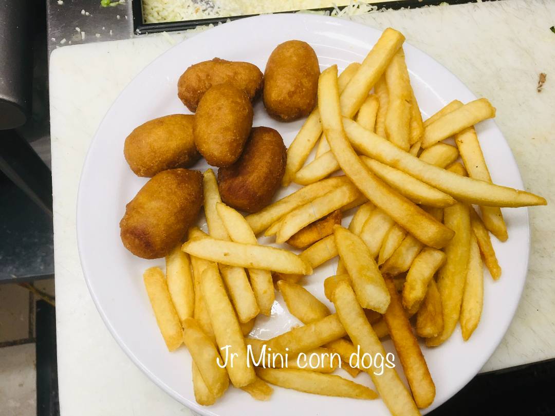 Mini corndog plate served with fries.