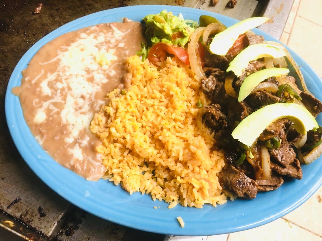 Blue plate filled with fried beans, rice and beef.