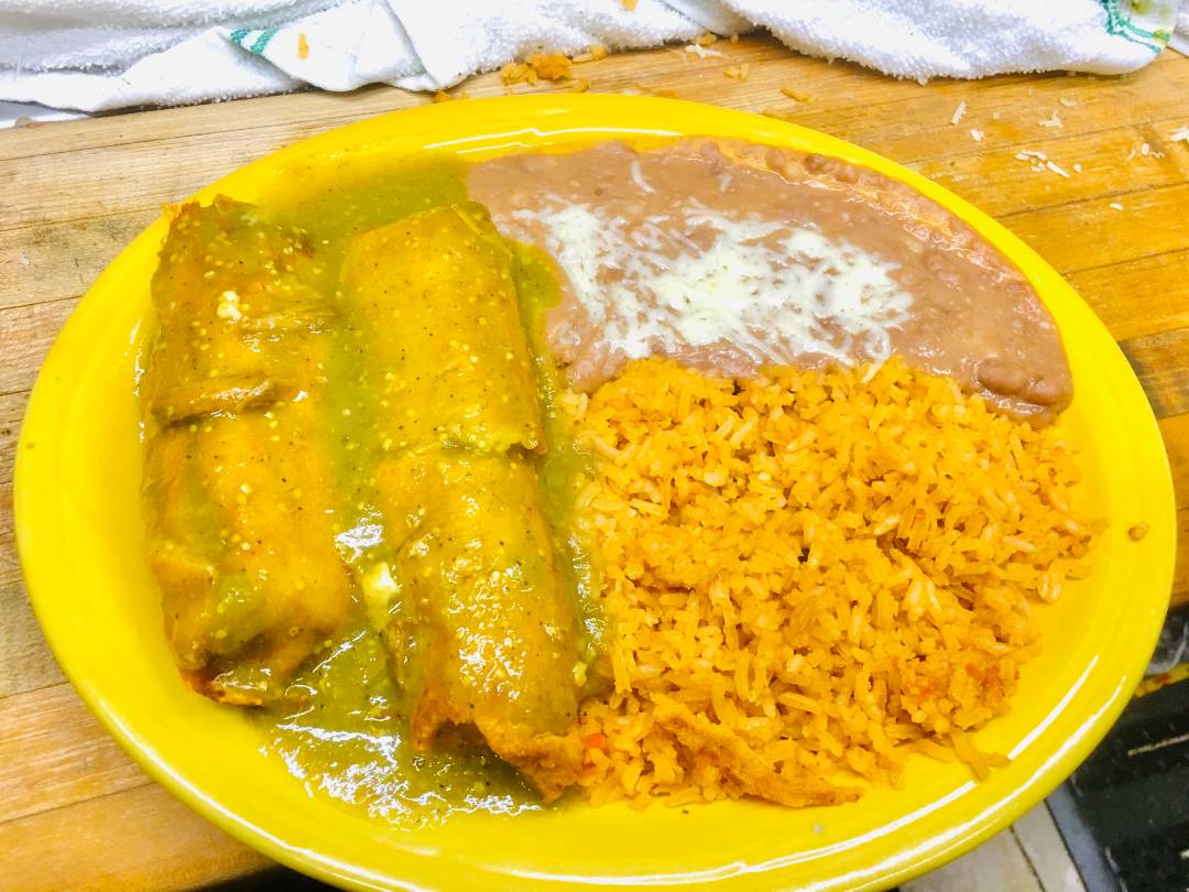 A vibrant spread of a traditional Mexican dish served with rice and beans.