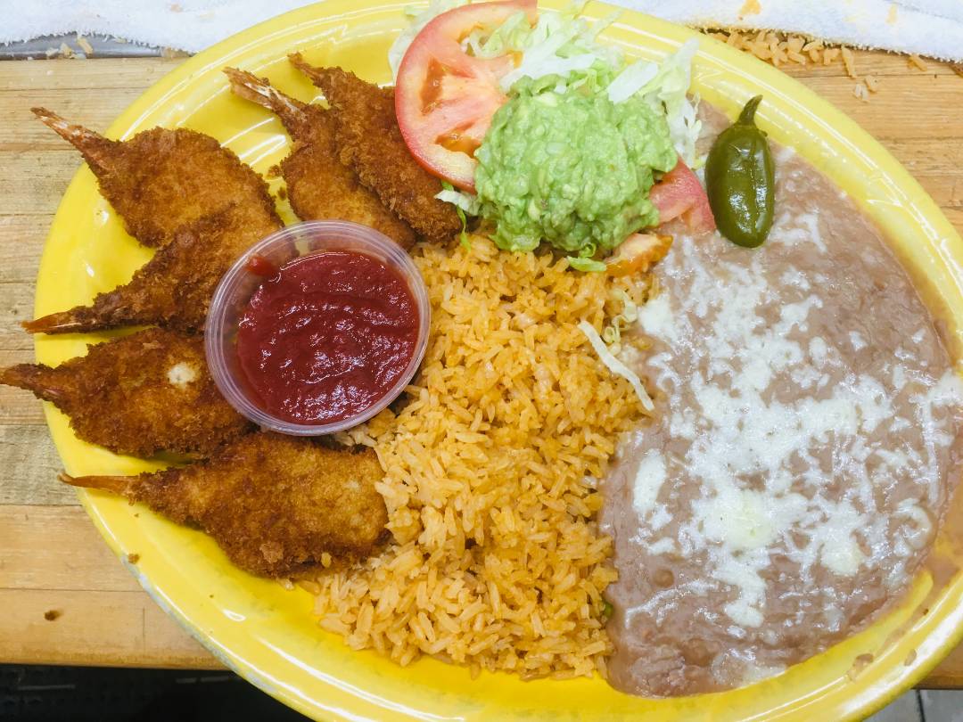 A yellow plate filled with rice, beans, and chicken.