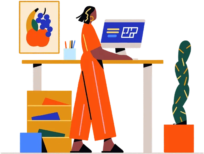 Person in orange outfit working at desk with computer and colorful items
