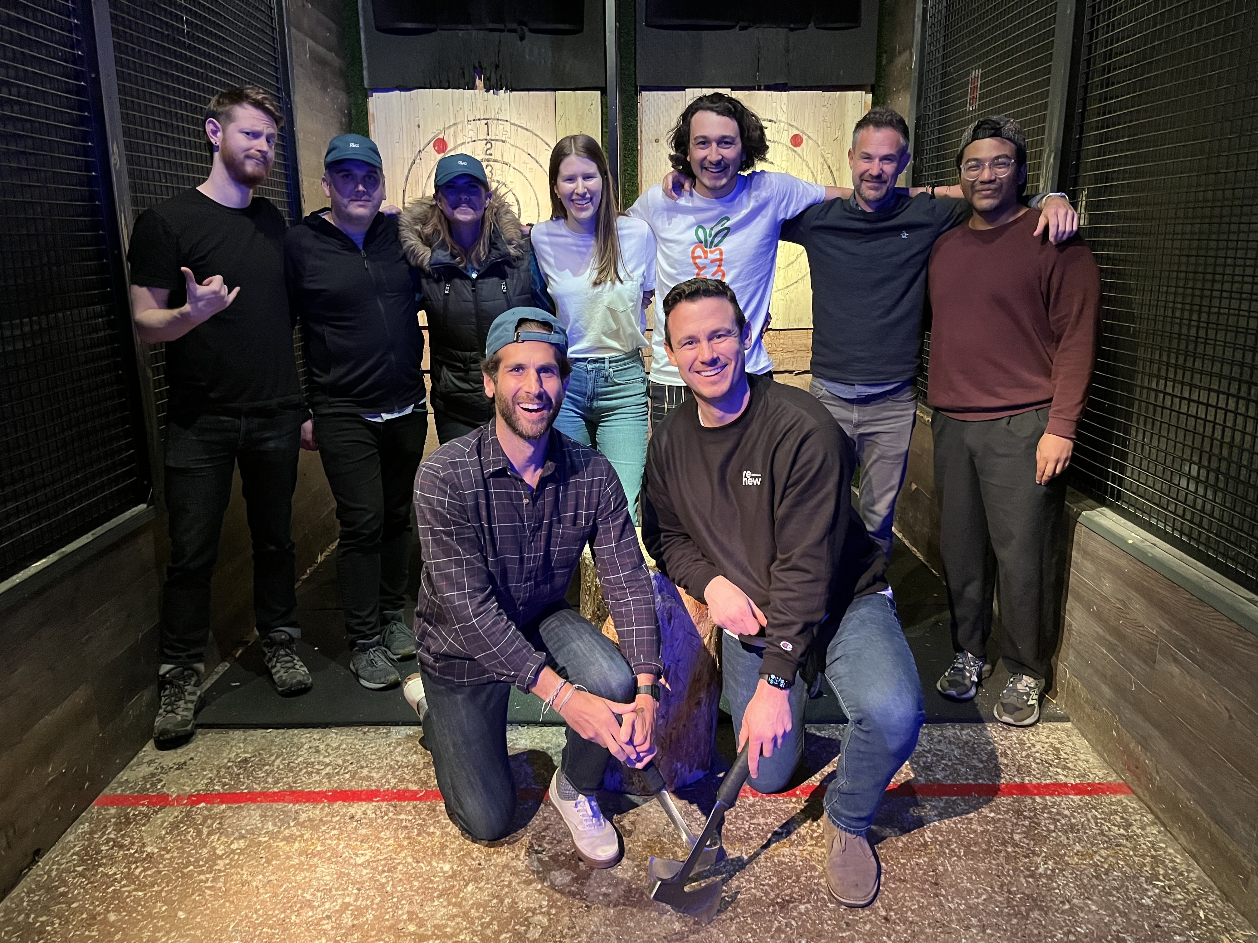 Group photo at axe-throwing venue with friends posing together