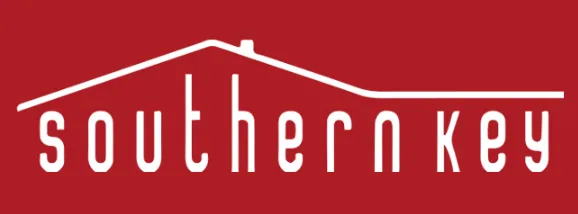 A white minimalist logo for "southern key" featuring a simple house roof outline on a solid red background.