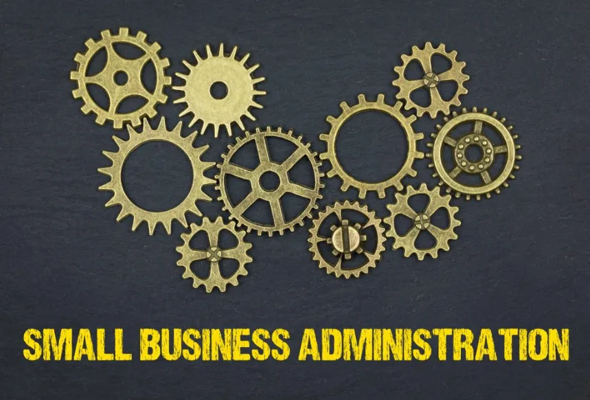 A collection of gold-colored interlocking gears on a dark background with the text "SMALL BUSINESS ADMINISTRATION," representing the complex mechanics of federal loan programs.