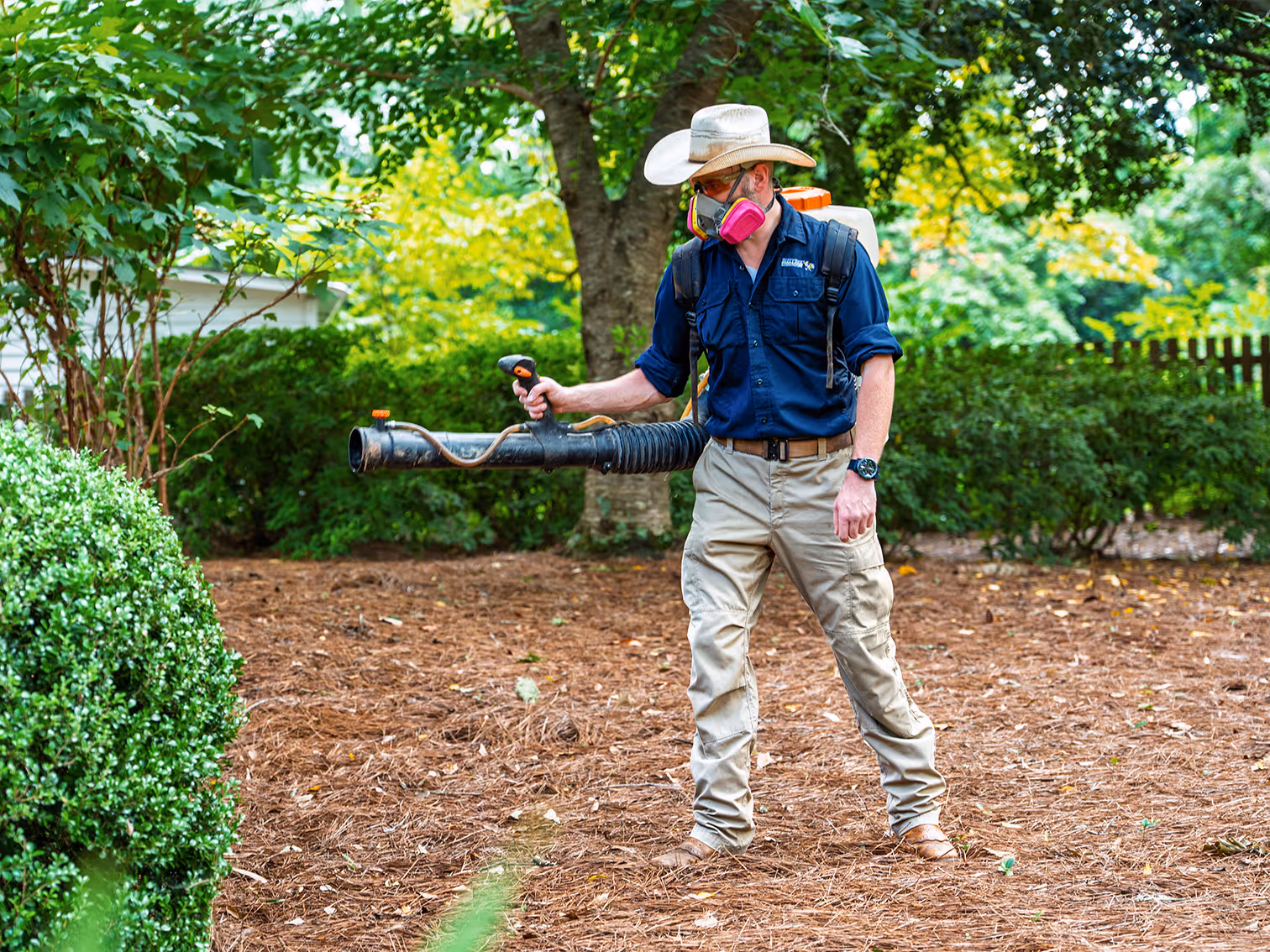 pest control pro spraying yard for mosquitoes