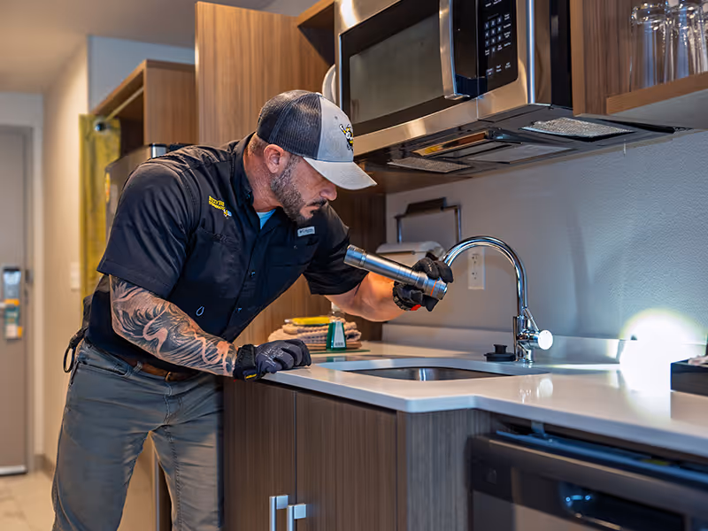 technician inspecting hotel room