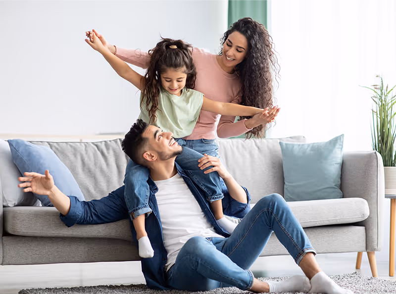 family relaxing on couch
