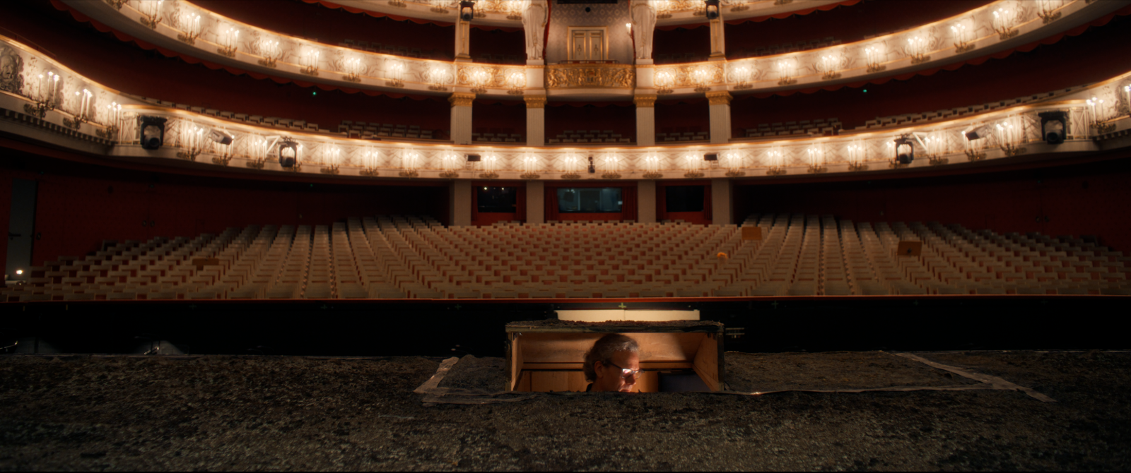 The opera everyone applauds is built by the people no one ever sees. Twenty-nine of them — one portrait at a time.