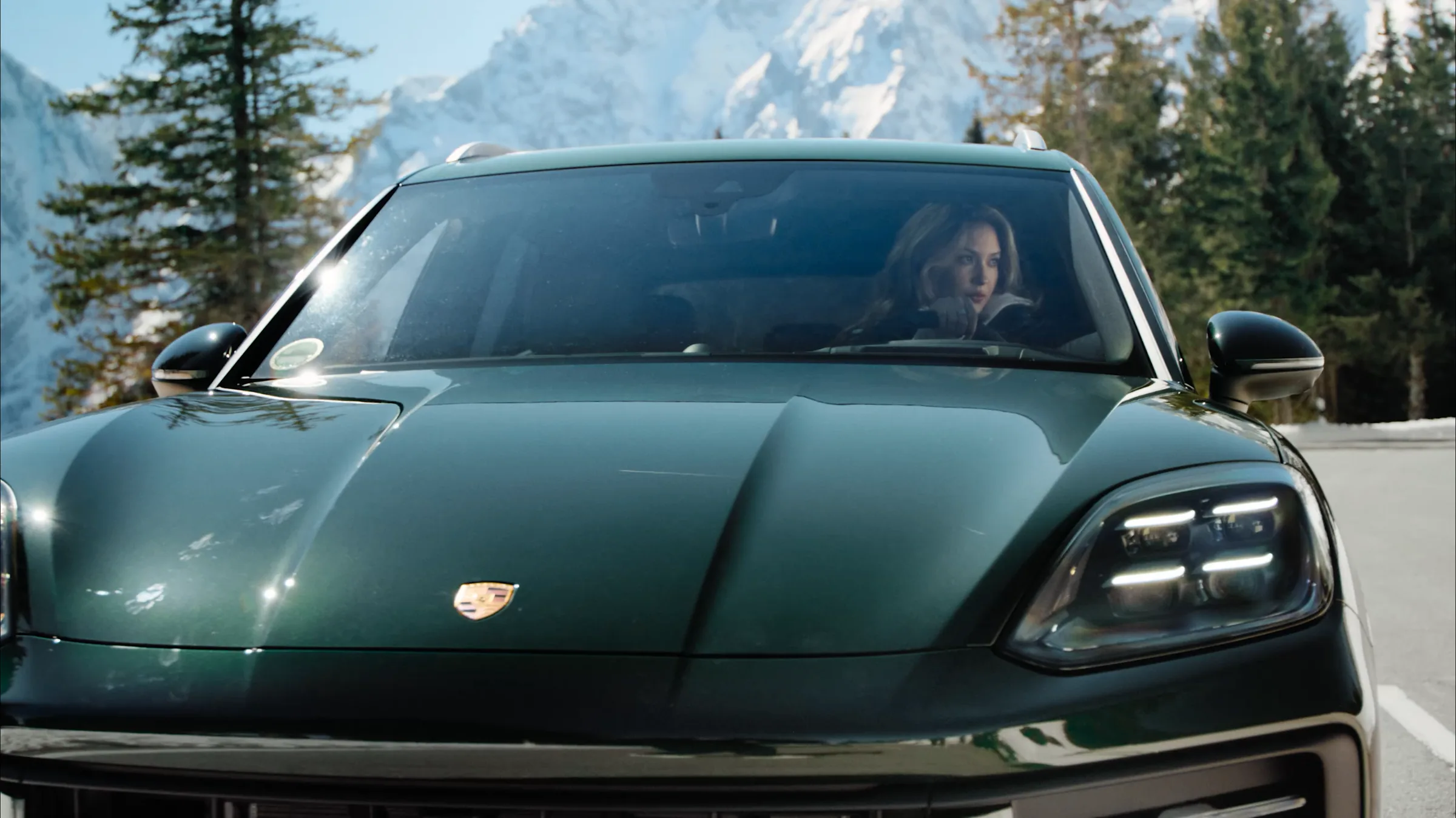 Porsche Cayenne Active head on with Eileen Gu driving through the Berchtesgaden Alps, film still by IVORY Productions