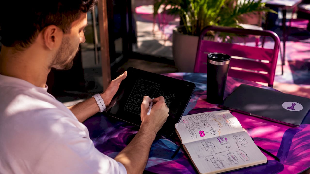 Close-up of hands sketching user interaction wireframes