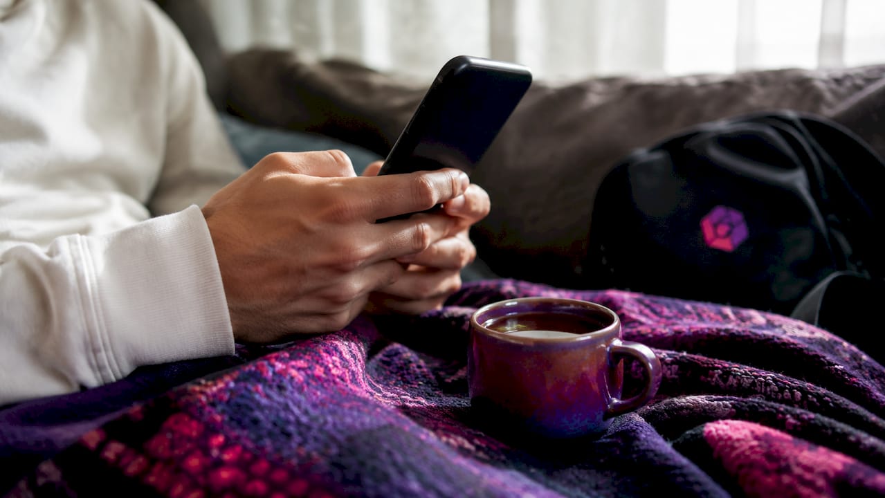 Hands holding smartphone showing comfortable thumb reach