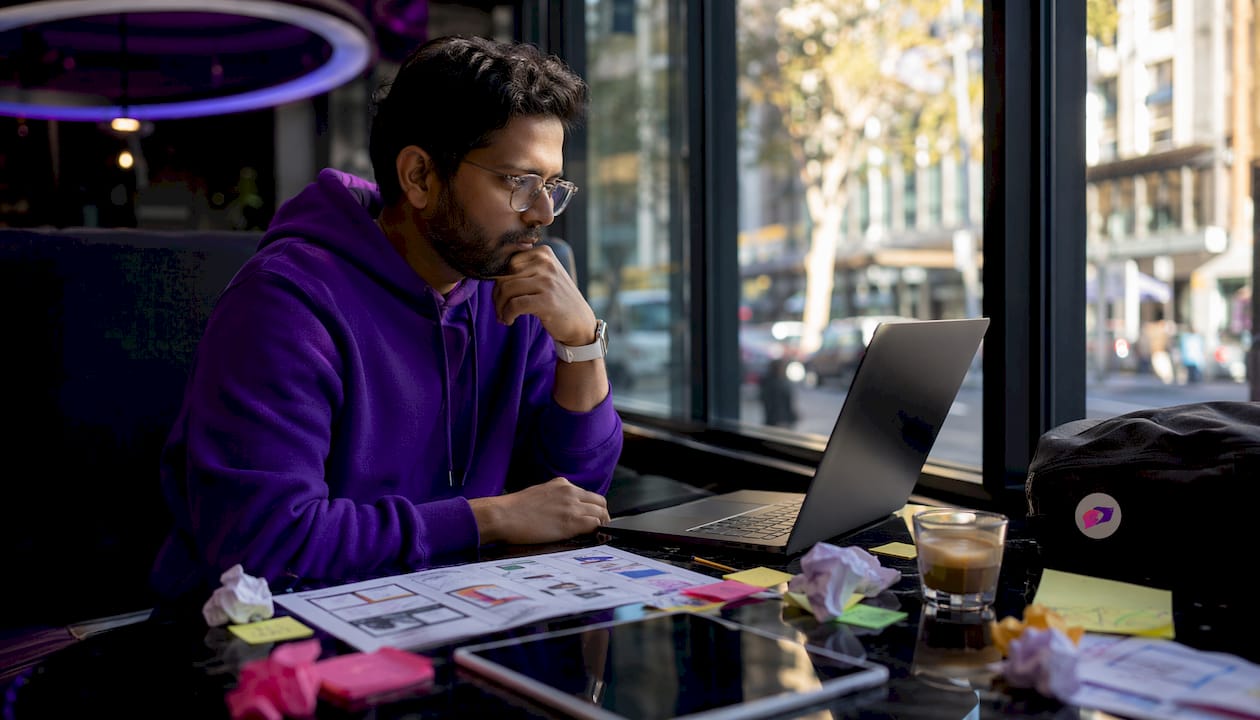 UX designer contemplating cognitive friction at desk