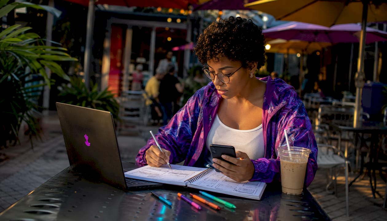 Woman testing mobile design at desk