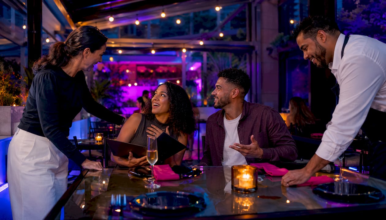 Host seating guests in elegant restaurant