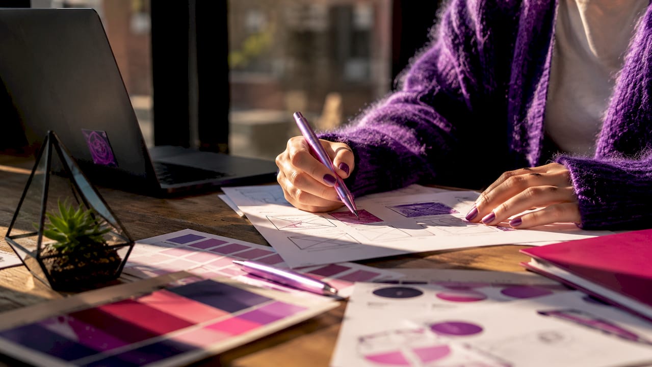 Overhead view of website design materials spread on desk