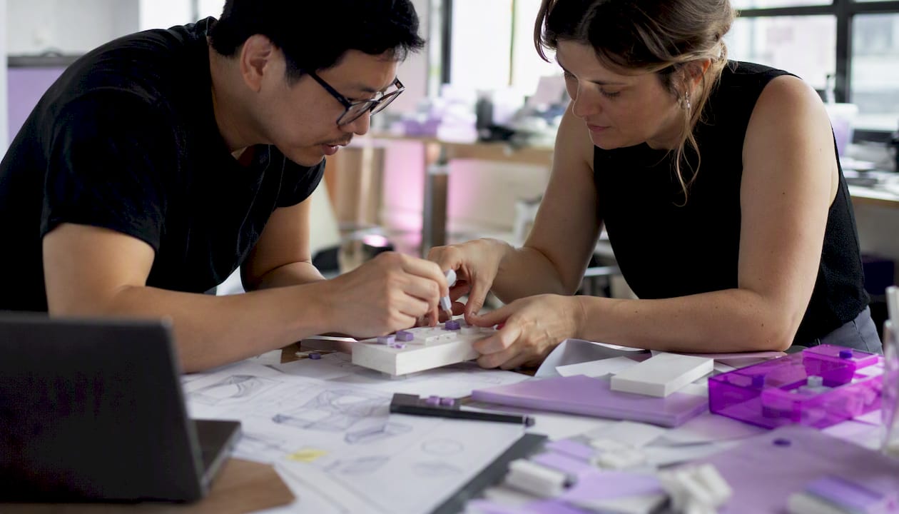 Engineer and designer refining a prototype
