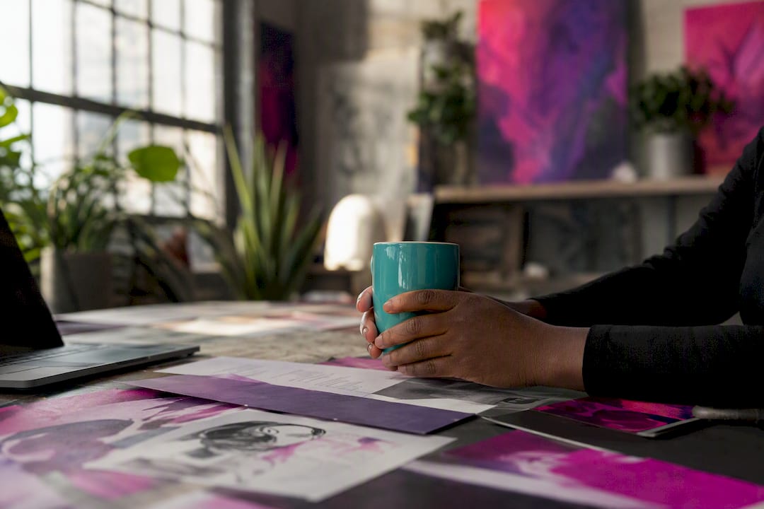 Hands holding coffee mug in reflection