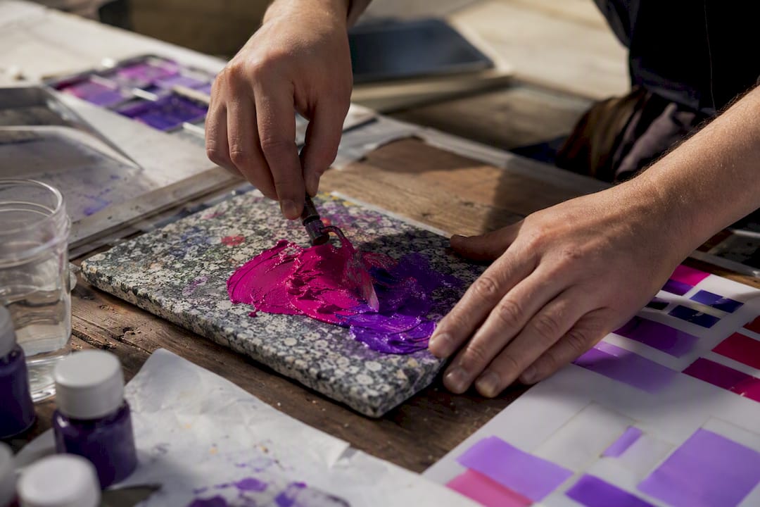 Designer hands mixing vibrant paint colors