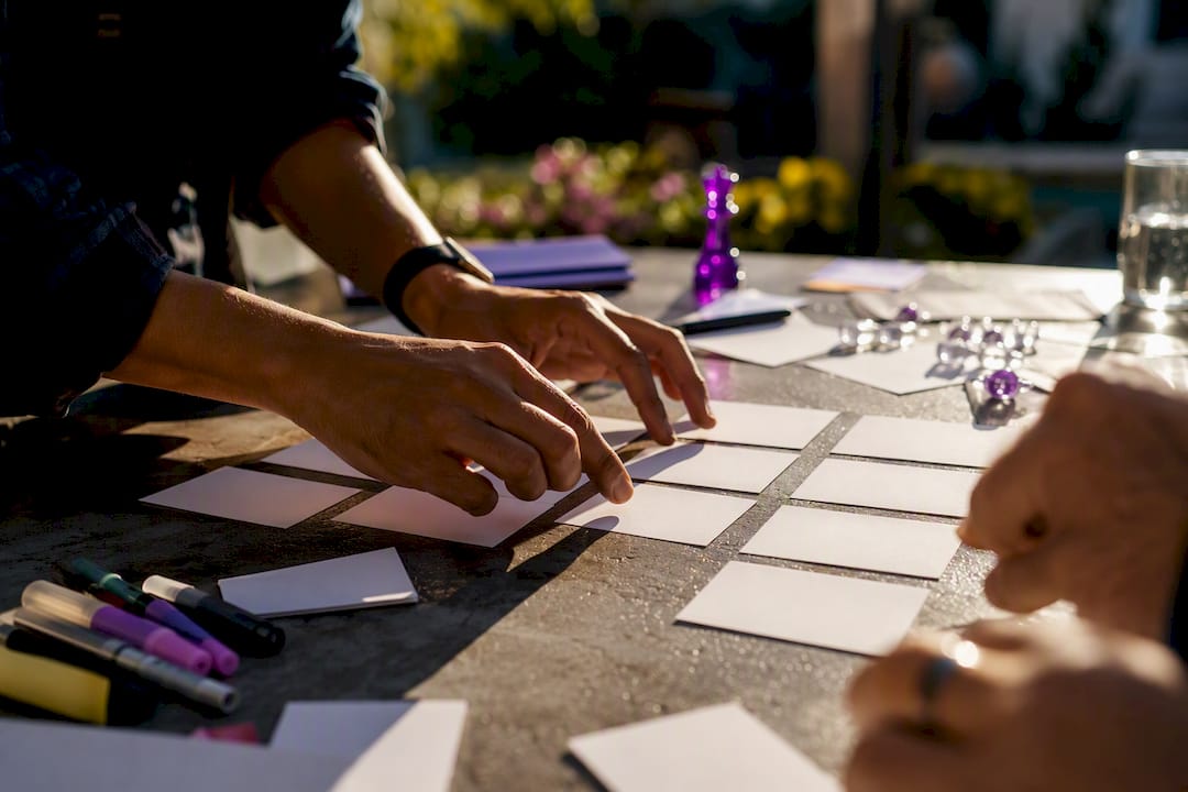 Hands planning email launch sequence