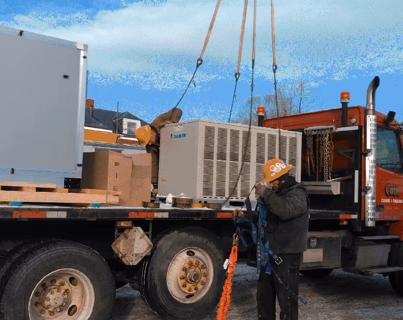 Maine Preventative Maintenance preparing to hoist and install a commercial rooftop HVAC unit.