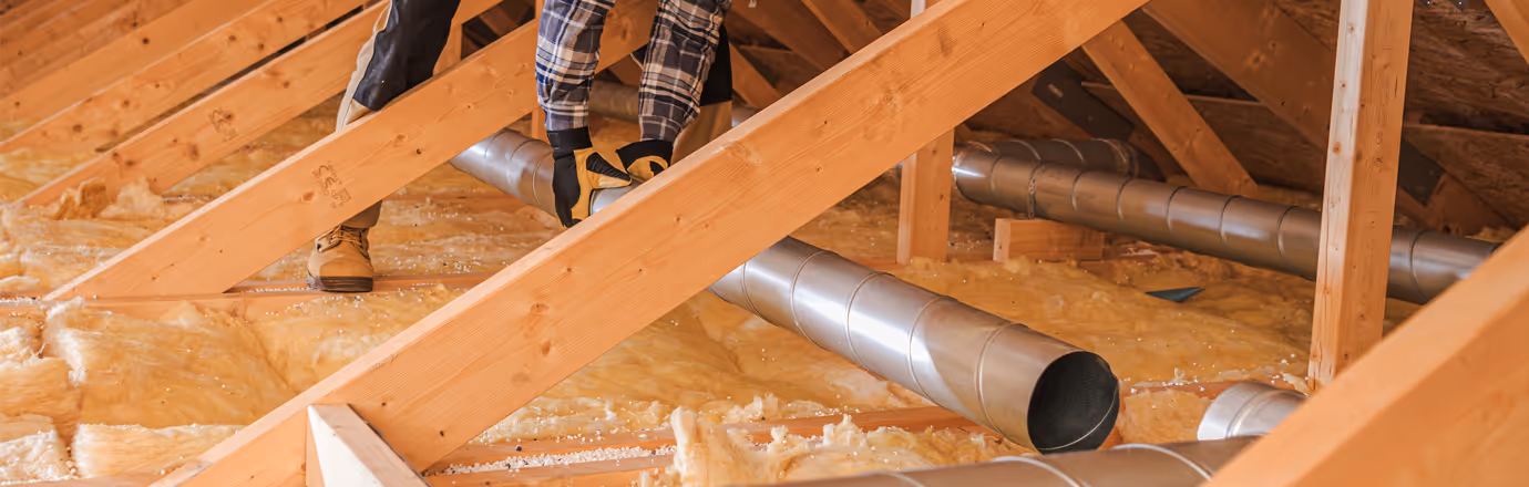 Air quality specialist installing new residential air duct system in a home.