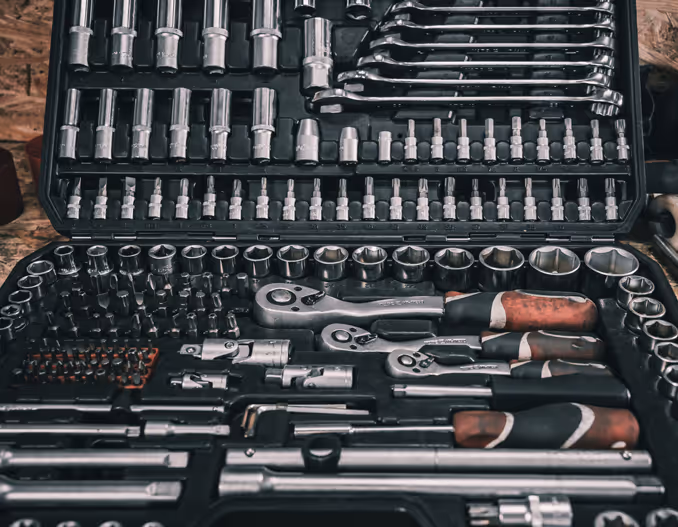 Various hand tools, including wrenches, screwdrivers, and pliers, arranged in a toolbox