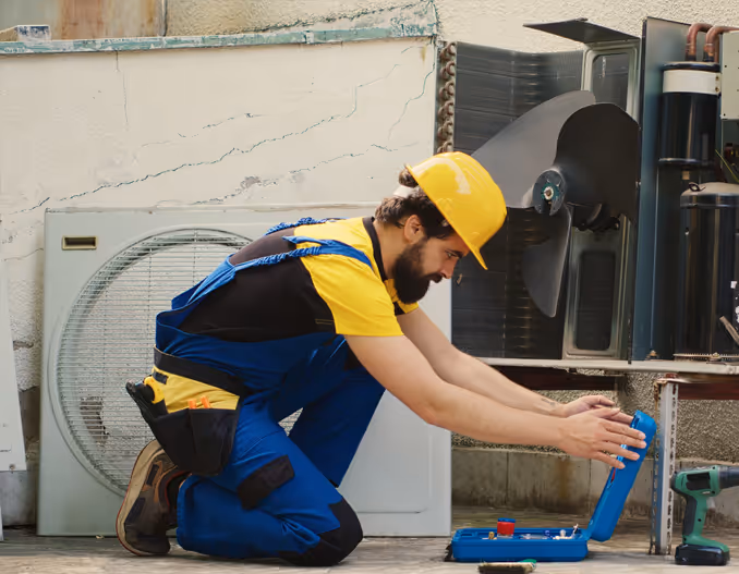 Engineer inspecting HVAC system, checking ducts and equipment during routine maintenance.”