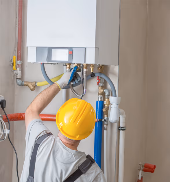 Experienced plumber repairing pipes with a wrench in a residential setting