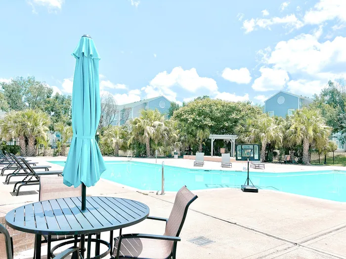 pool with tables with umbrellas