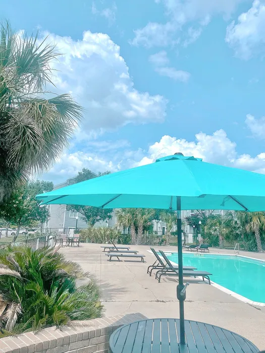 pool with tables with umbrellas
