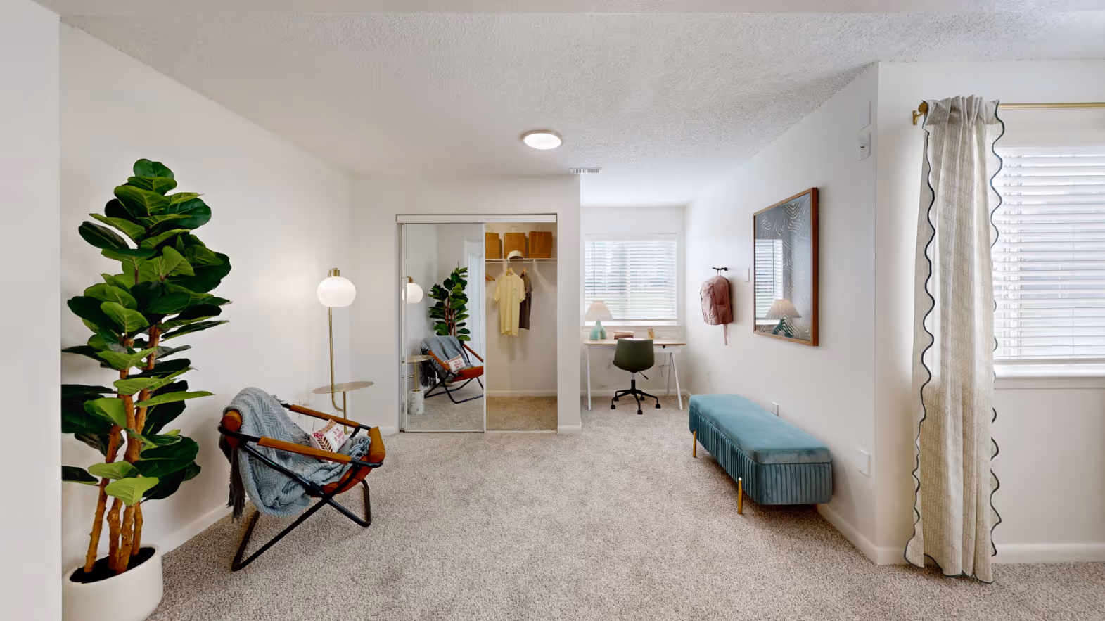 large bedroom with desk and view of closet