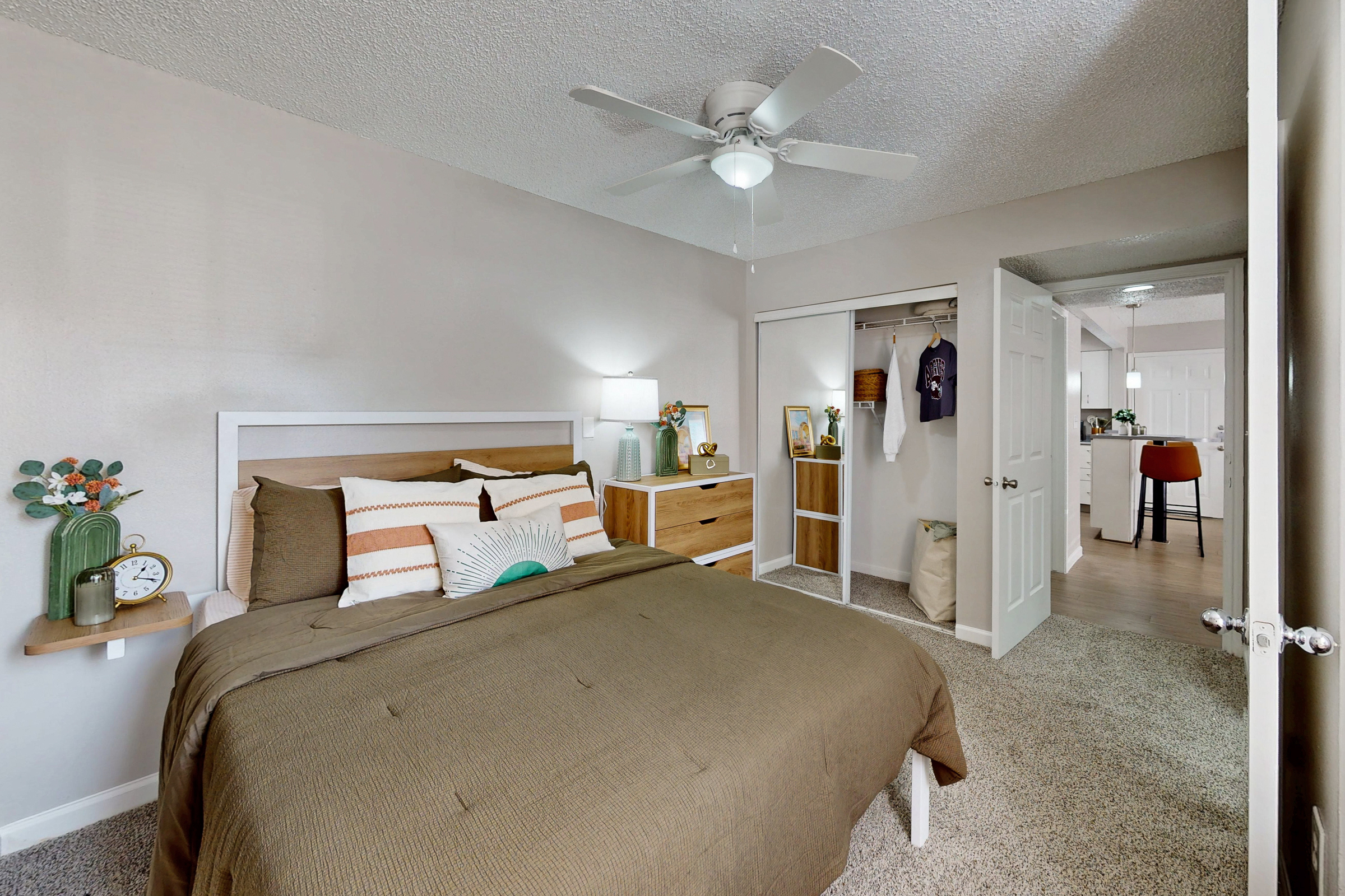 kitchen with stainless steel refrigerator, white cabinets, and view of laundry room with white appliances
