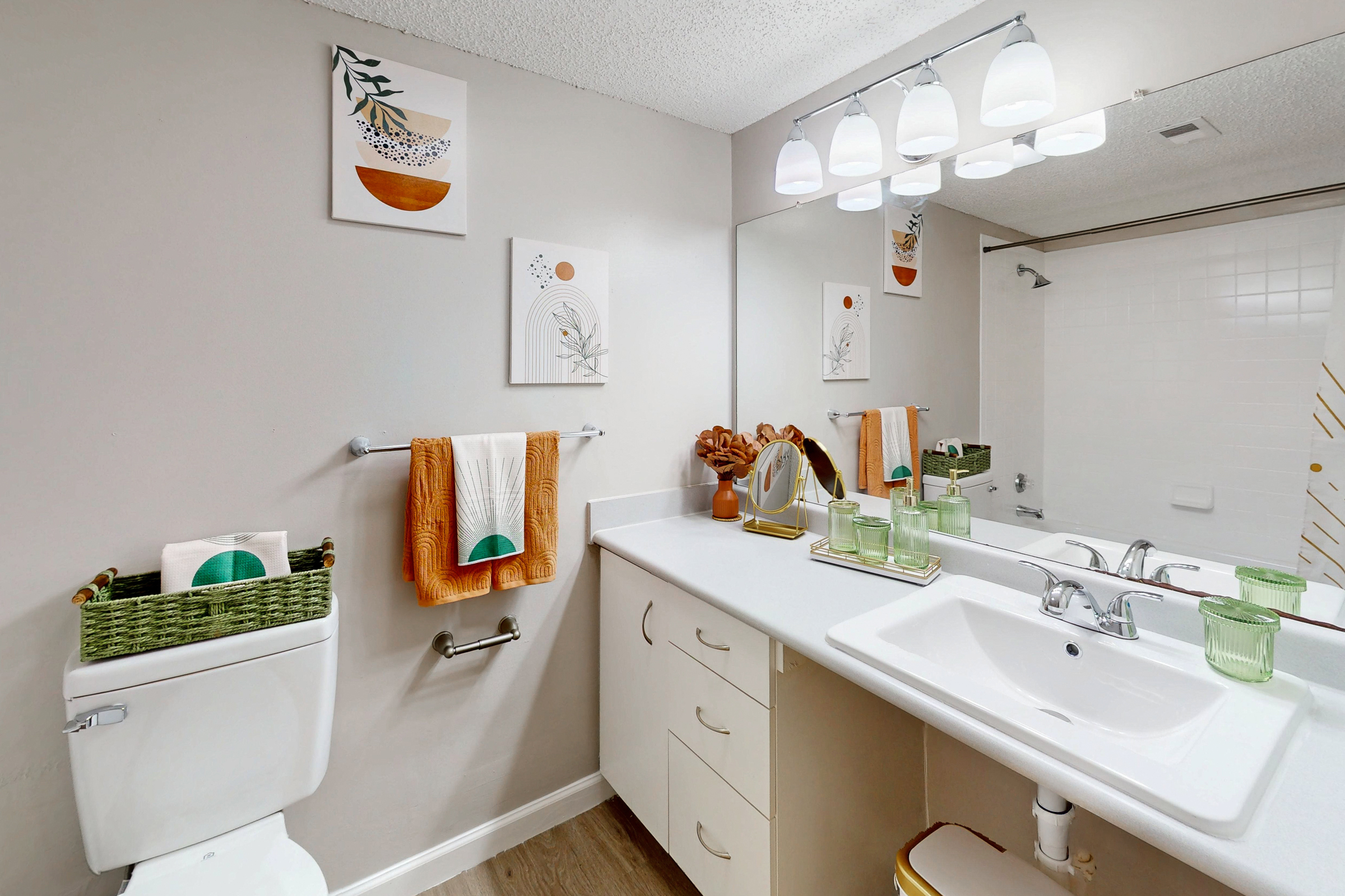 A dedicated laundry closet with a side-by-side white washer and dryer unit, featuring a wire shelf above for storage.