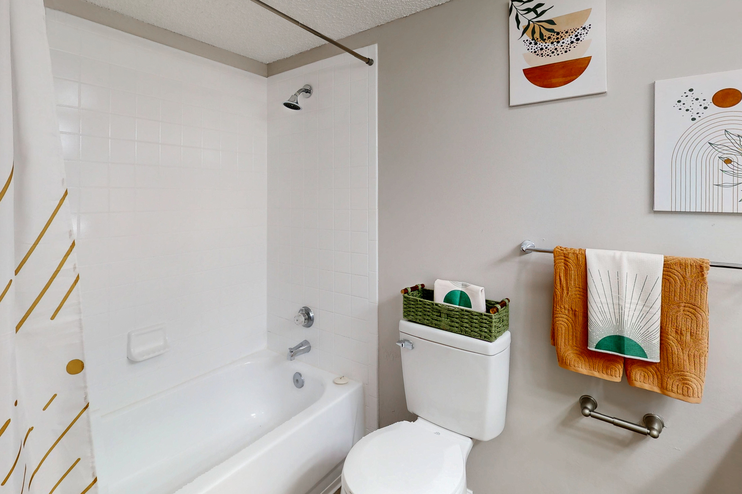 large bedroom with bed, closet with hangers, desk and window