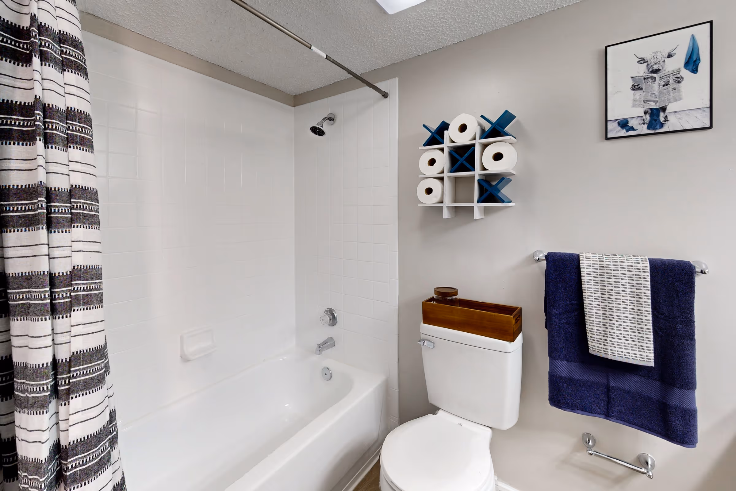 Bathroom with vanity mirror and white drawers and cabinets 