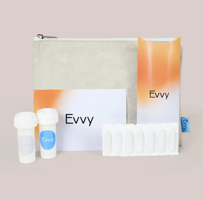 An Evvy treatment program including prescription pill vials, suppositories, and instruction cards