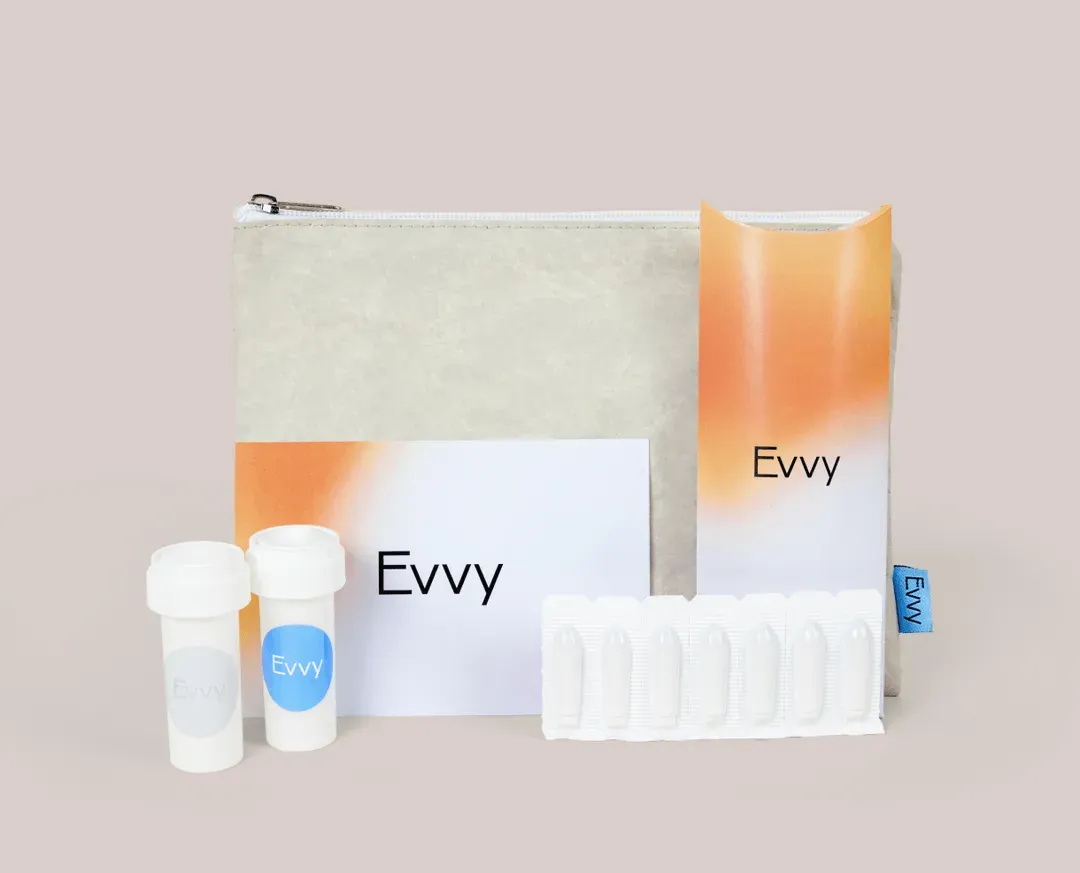 An Evvy treatment program including prescription pill vials, suppositories, and instruction cards