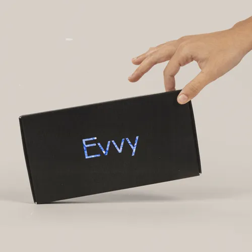Hand holding a black Evvy box