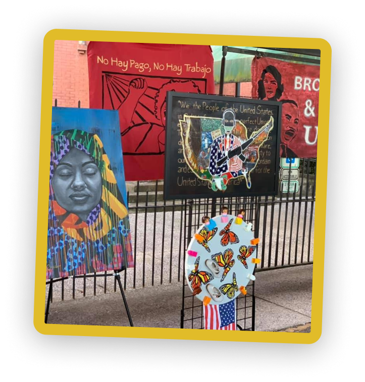 Colorful street art featuring portraits, intricate designs, and butterfly motifs against a building backdrop.