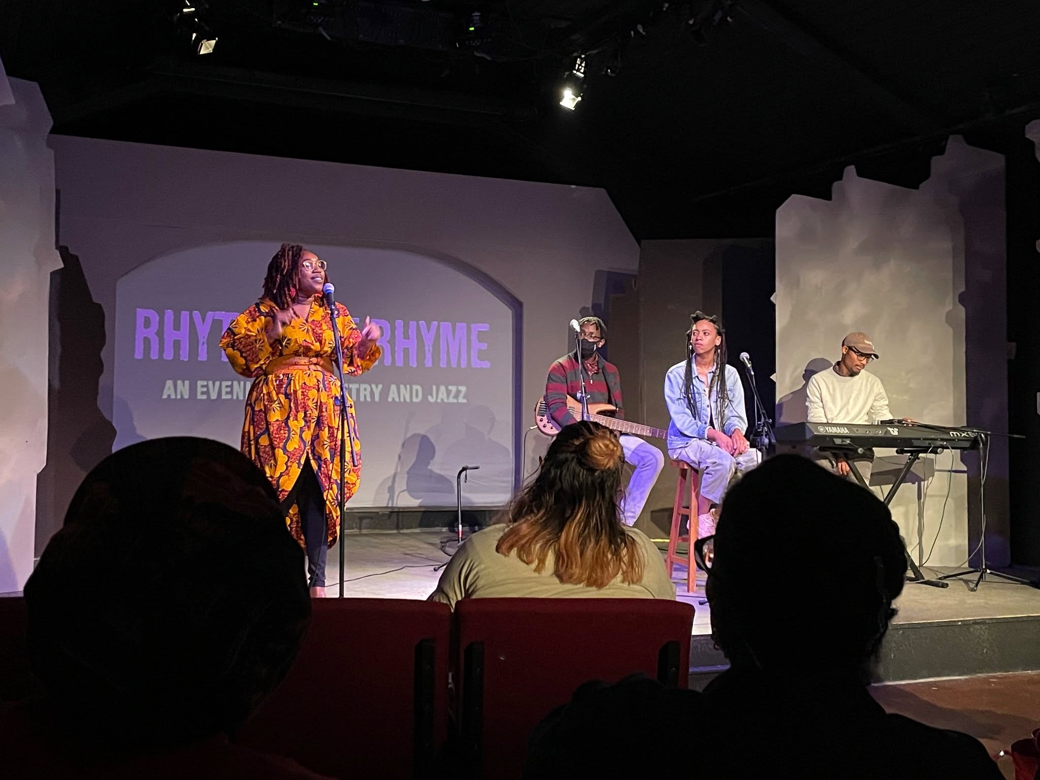 Person viewing wall art in a gallery; includes text and graphic designs in frames.