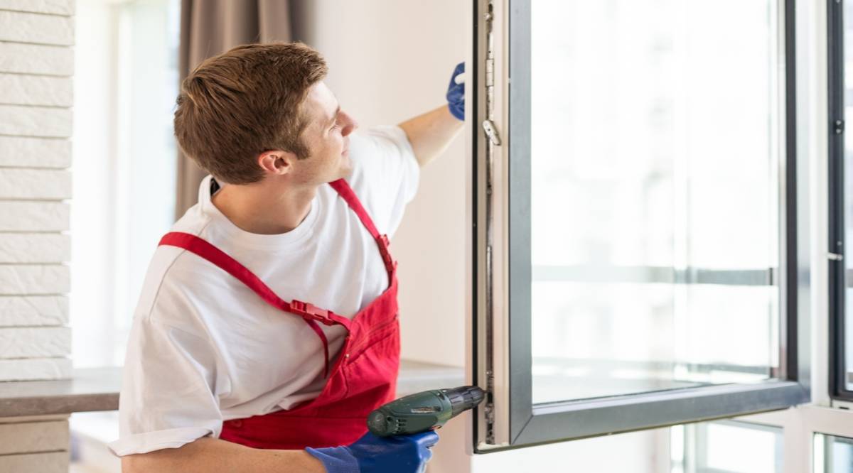 Construction worker installing a window